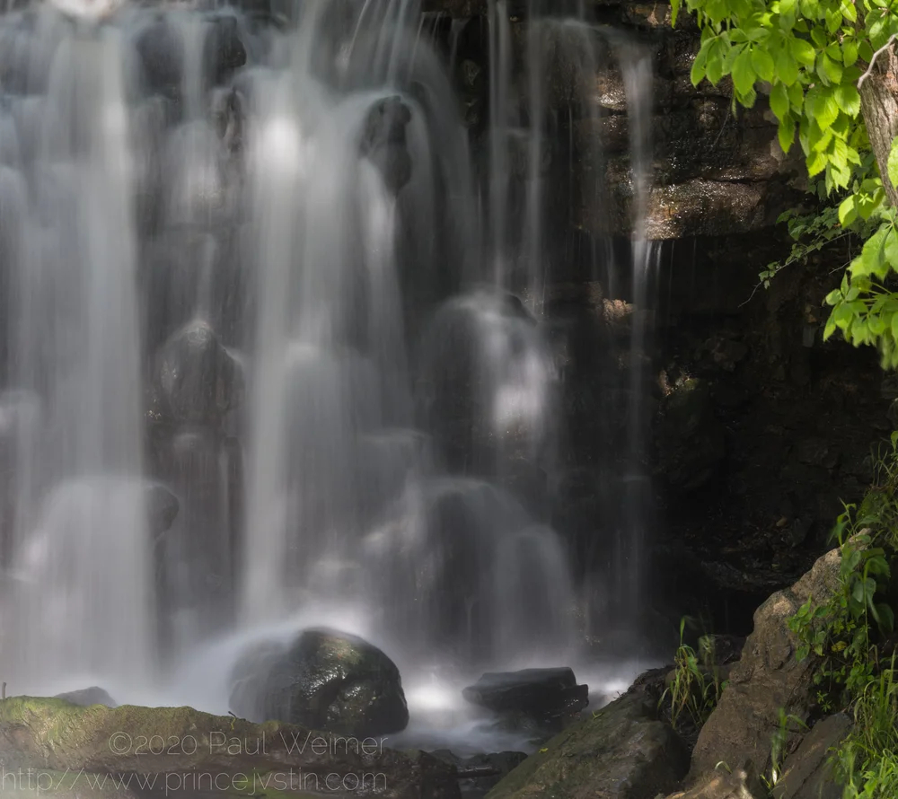 a shaded waterfall, slow shutter speed.